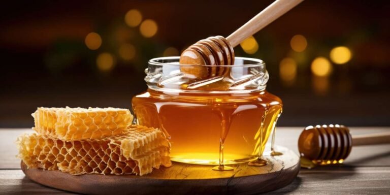 honey dripping from dipper into jar set against wooden tones 11533552591